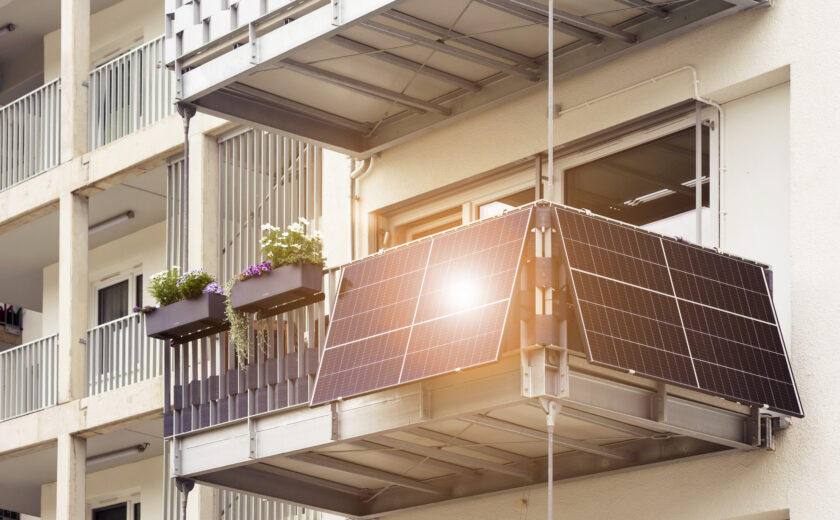 Solar Panel on Balcony Flat or Apartment Building. Solar Modern Balcony with Sun Light Reflection in Green City. Solar Technology Equipment. Green Energy Concept.